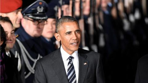 Barack Obama makes his way to his car after disembarking from Air Force One on November 16, 2016 at Berlin's Tegel airport