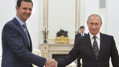 Bashar al-Assad and Vladimir Putin shaking hands