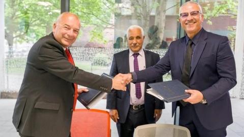 Coventry University vice-chancellor Professor John Latham CBE shakes hands with Professor Tariq Obaid, president of BSESP, as Mohamed Tahiri, director of higher education at the Moroccan Department of Higher Education, watches on