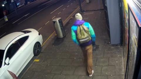 CCTV of the man, who is described as having light brown hair and was wearing light brown trousers and a blue, green and purple jacket.