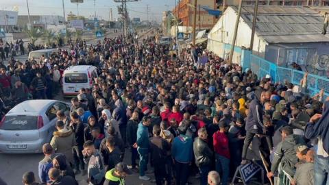 Hundreds of people queuing for food