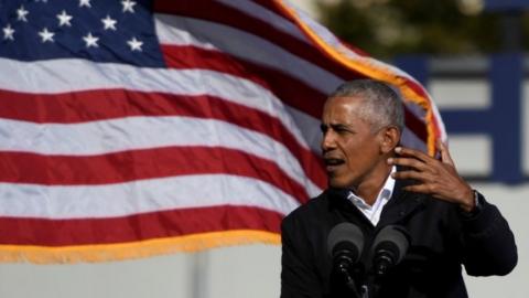 Former President Barack Obama addresses voters one day before the election, in Atlanta