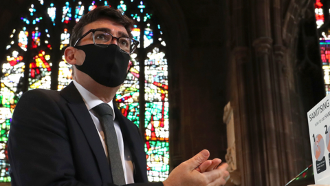 Andy Burnham sanitises his hands at Manchester Cathedral