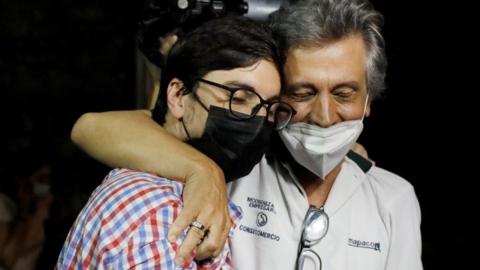 Venezuelan opposition leader Freddy Guevara hugs his father after leaving "El Helicoide" in Caracas, Venezuela August 15, 2021.