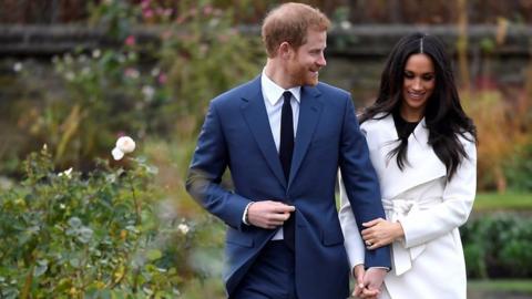 Harry and Meghan walk hand in hand