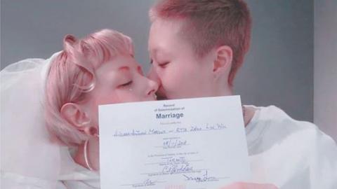 The Instagram picture of Etta Ng and Andi Autumn kissing and holding their marriage certificate