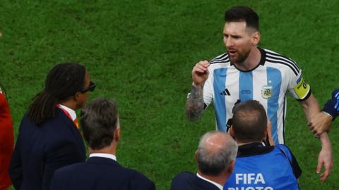 Argentina forward Lionel Messi gestures to Netherlands coach Louis van Gaal and his assistant Edgar Davids after his side beat the Dutch in penalty shootout at the 2022 World Cup