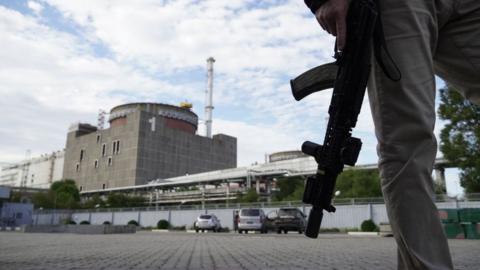 A security guard stands in front of the Zaporizhzhia nuclear plant on 11 September