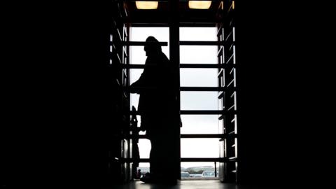 Generic shot of a fan going through a turnstile