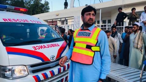 An ambulance arriving to hospital following the explosion in Pakistan