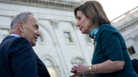 Senate Majority Leader Chuck Schumer talks with Speaker of the House Nancy Pelosi