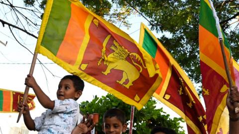 Children holding Sri Lankan flags after the election of Gotabaya Rajapaksa