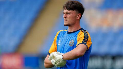 Elyh Harrison warms up for Shrewsbury Town