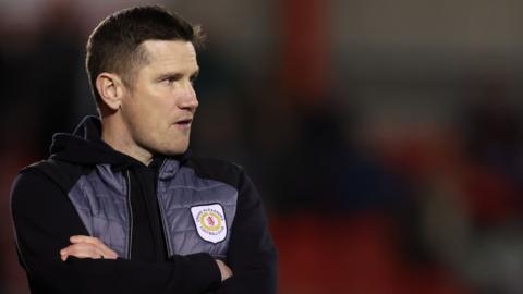 Crewe boss Lee Bell watches on from the sidelines during the game against Sutton United