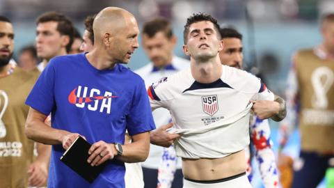 Gregg Berhalter talks to Christian Pulisic after the United States' World Cup exit