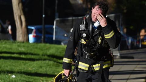A firemen reacts after battling the huge fire at the Grenfell Tower