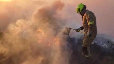 A fire fighter tackling the flames