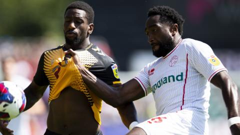 Omar Bogle of Newport County in action against Emmanuel Monthe of Walsall