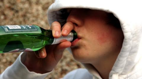 Teenage boy drinking beer