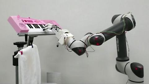 A robotic arm playing the piano
