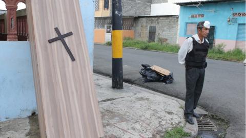 A man sells caskets on 29th Street and Oriente, a suburb of Guayaqui