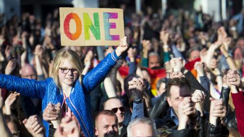 People hold hands during the Hand in Hand for Diversity, a demonstration against anti-LGBT violence triggered after a gay couple was beaten up, on April 8, 2017 in Arnhem