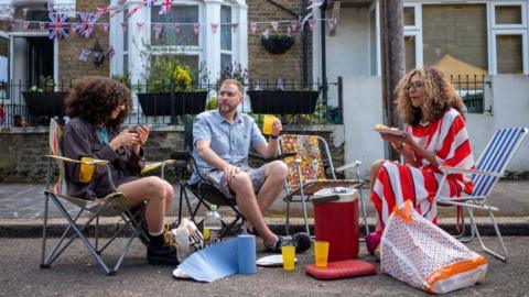 People having King's Coronation Street Party