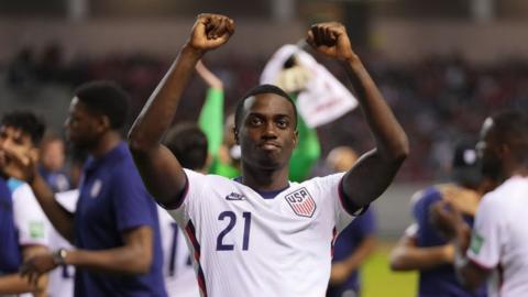 USA player Tim Weah celebrates qualifying for the World Cup