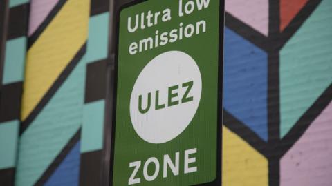 File image showing a ULEZ sign against a colourful painted wall.