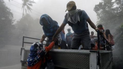 Residents living near the erupting Taal Volcano evacuate from Lemery, Batangas