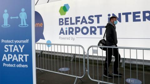 Man in mask at Belfast International Airport