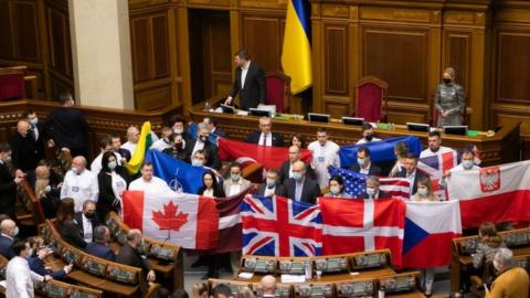 Members of various parties hold foreign countries' national flags during the 7th session of the Verkhovna Rada of the 9th convocation