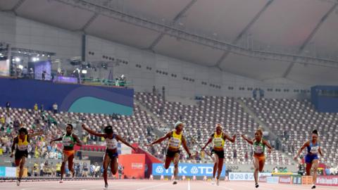 The women's 100m final at the World Championships takes place with a sparse crowd at the Khalifa International Stadium