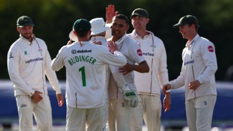 Leicestershire players celebrate a Derbyshire wicket