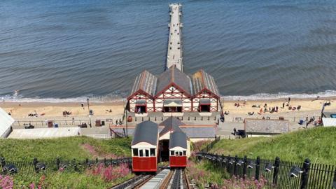 View looking down the cliff lift towards the pier at the bottom