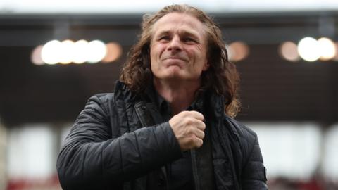 Gareth Ainsworth gestures towards the QPR fans