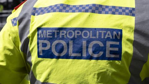 Back of a jacket that reads "Metropolitan Police"