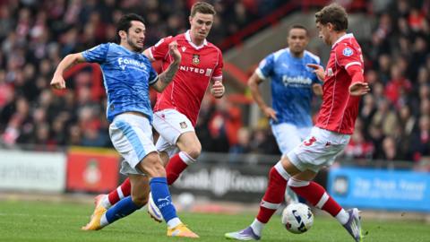 Derby County's Max Johnston (left) and Wrexham's Lewis Brunt (right) battle for the ball