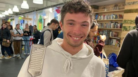 Eliott Marceau holding a cheese grater