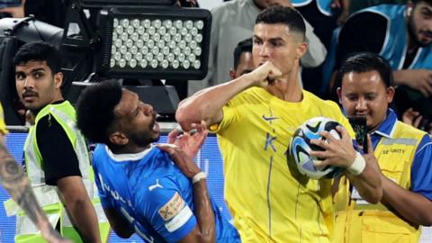 Al Nassr's Cristiano Ronaldo clashing with Al Hilal's Ali Al Bulayhi before being sent off