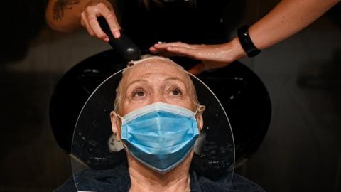 Woman having hair washed