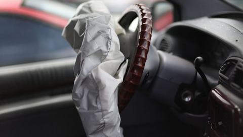 A deployed airbag inside a vehicle