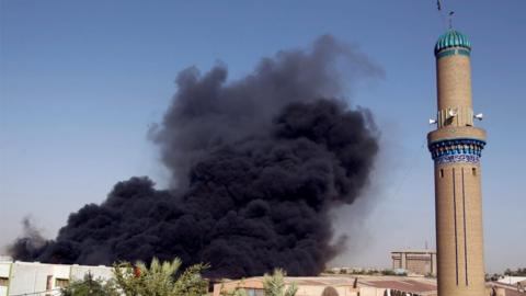 Smoke rises from a storage site in Baghdad - 10 June 2018