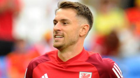 Aaron Ramsey warms up with Wales in June