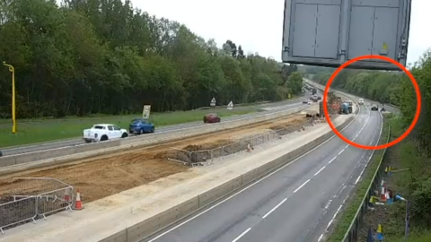 A black SUV driving on a closed-off A12