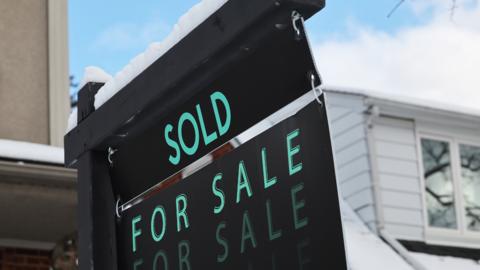 Sign outside a home for sale in Toronto, Canada.