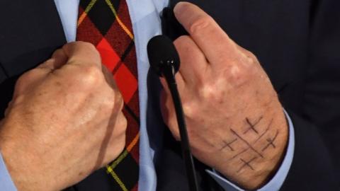 Symbol on Tom Steyer's hands