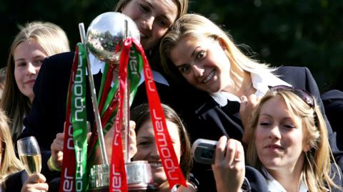 England's women's Ashes winners hold the trophy and take selfies on a bus tour
