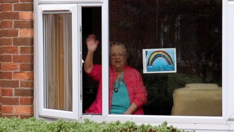 Woman waving at window