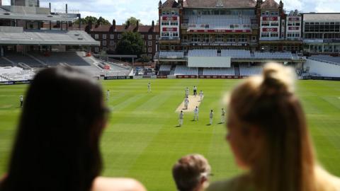 Spectators watch cricket